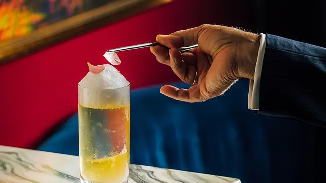 A cocktail from the Echoes of Memory menu being garnished at Velvet by Salvatore Calabrese.
