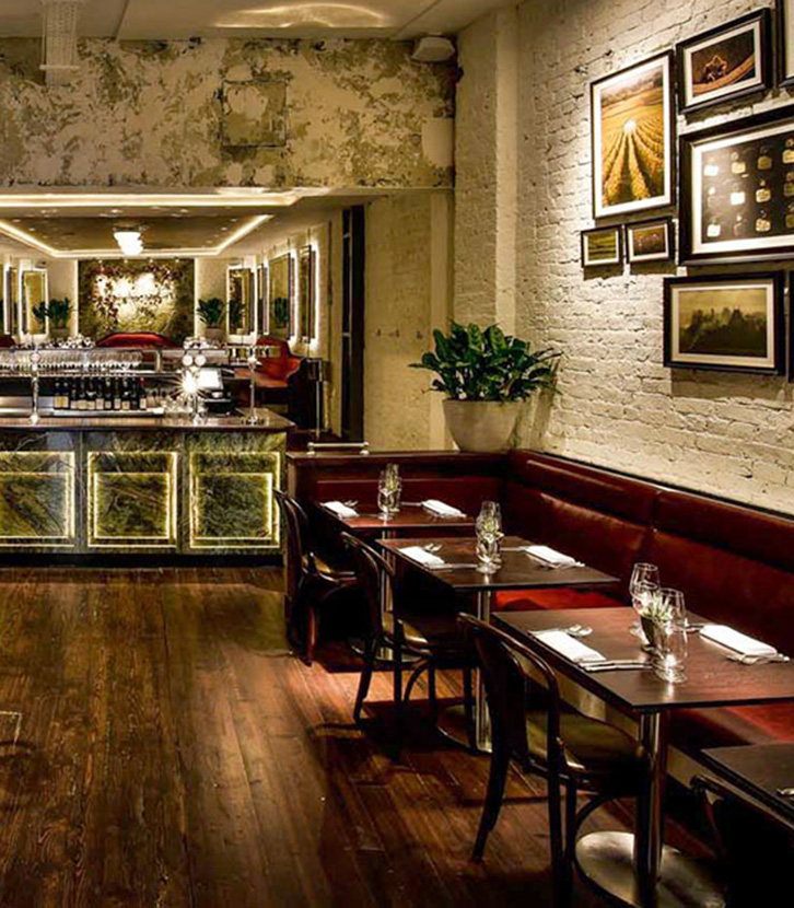 Da Terra in London, an upscale dining room with exposed brick walls and banquette seating.