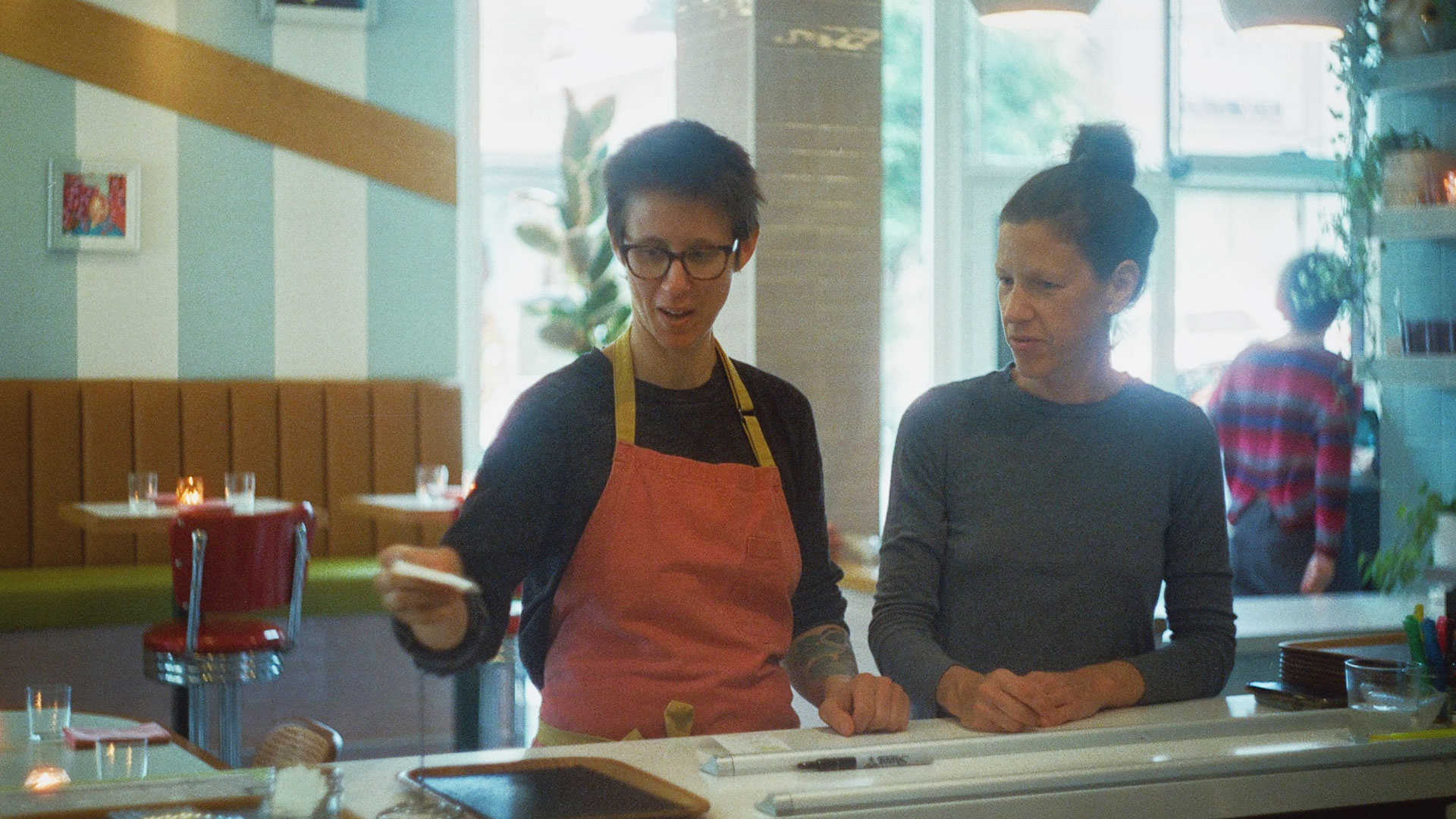 Restaurant staff at work in a dining environment.