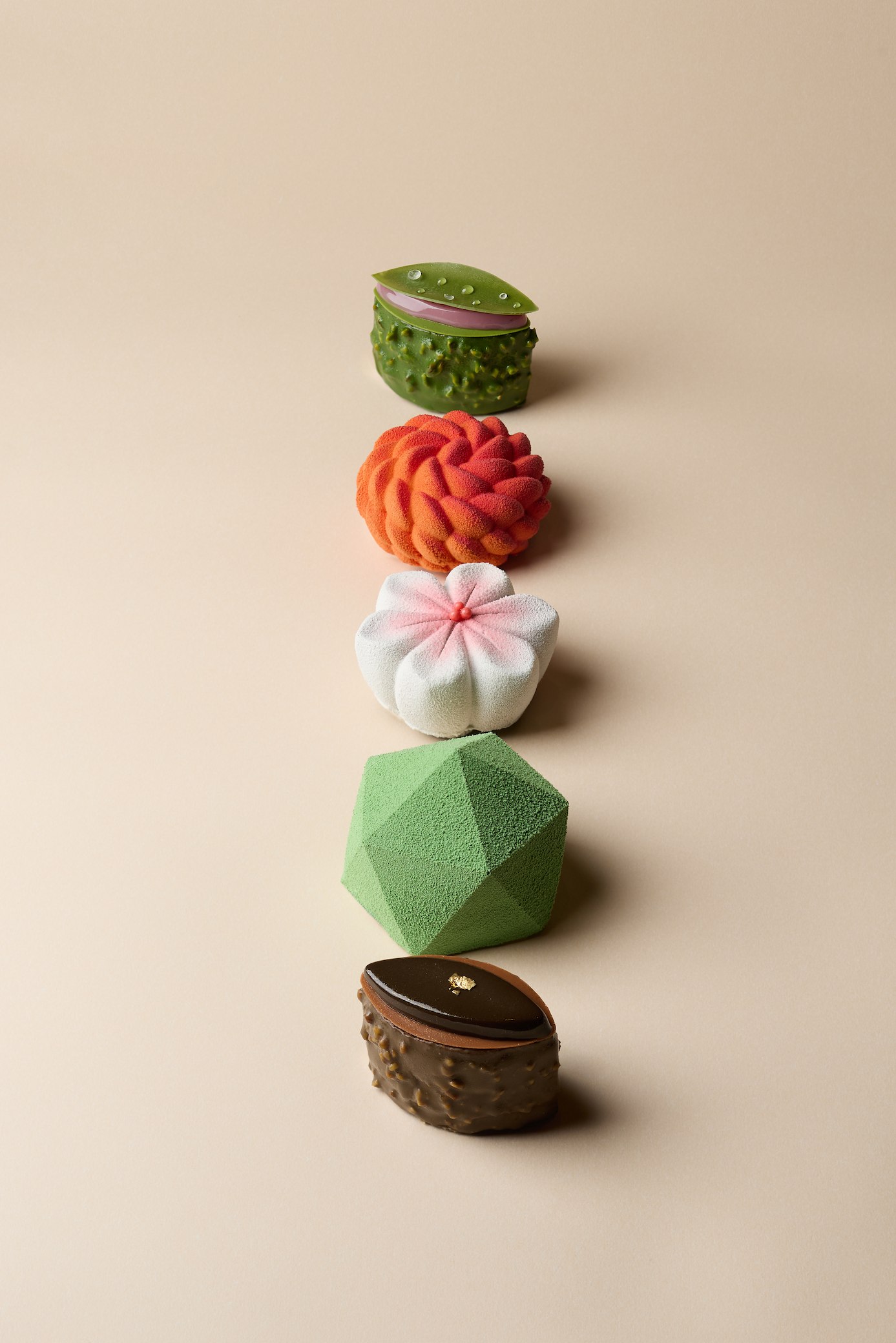 Five artisanal matcha desserts arranged vertically on a neutral background, showing signature items from KOKO Kawane including the textured green Mido