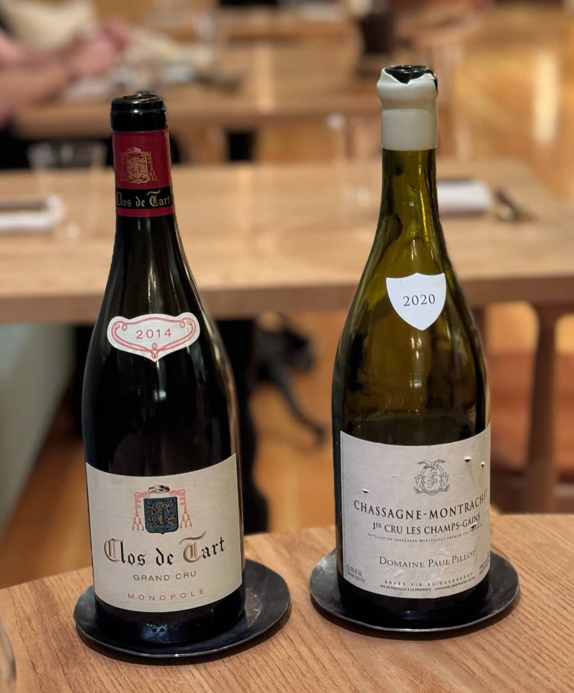 A bottle of 2014 Clos de Tart and bottle of 2020 Domaine Paul Pillot Chassange Montrachet Les Champs-Gains