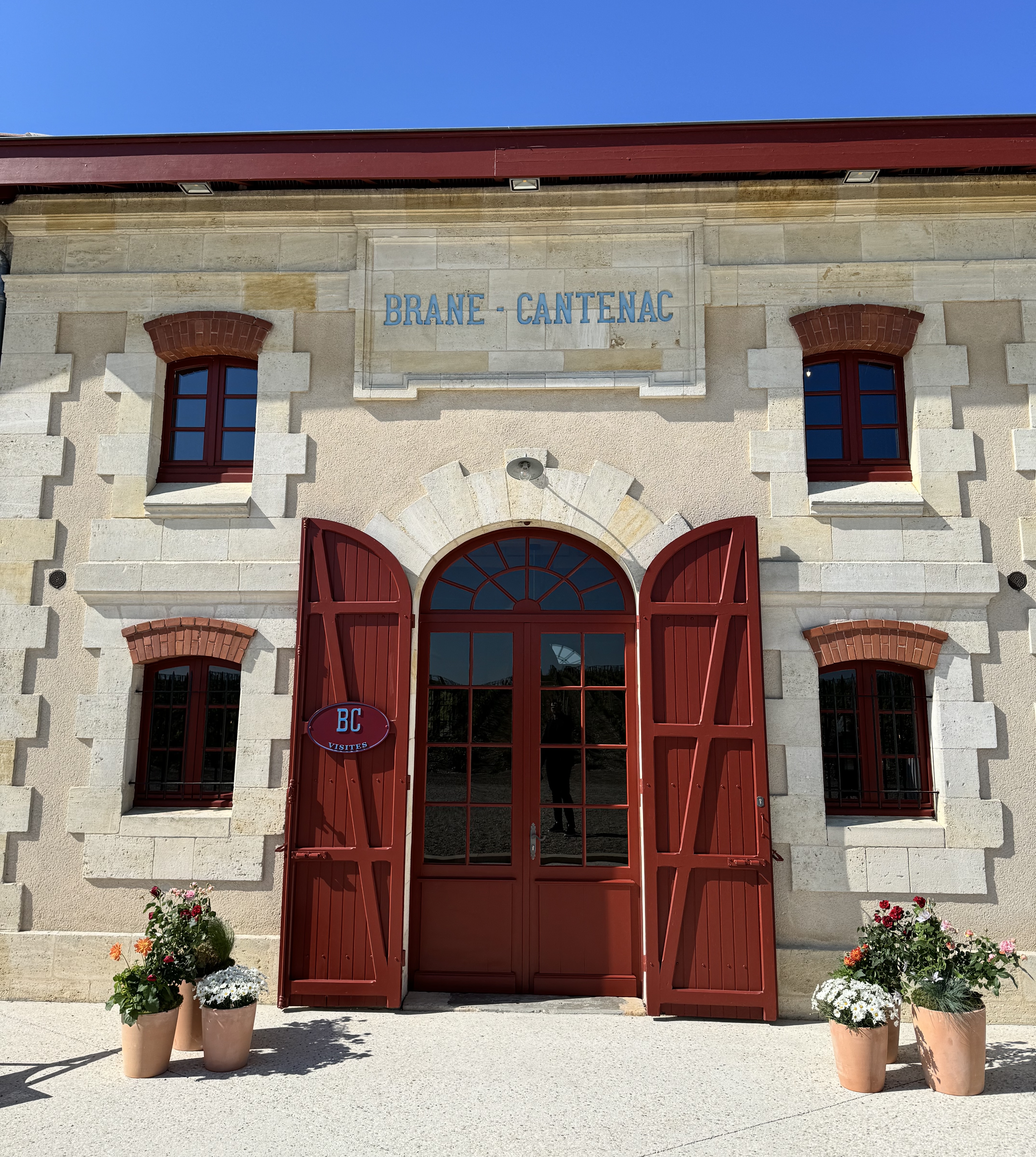 the entrance to a winery with a red door