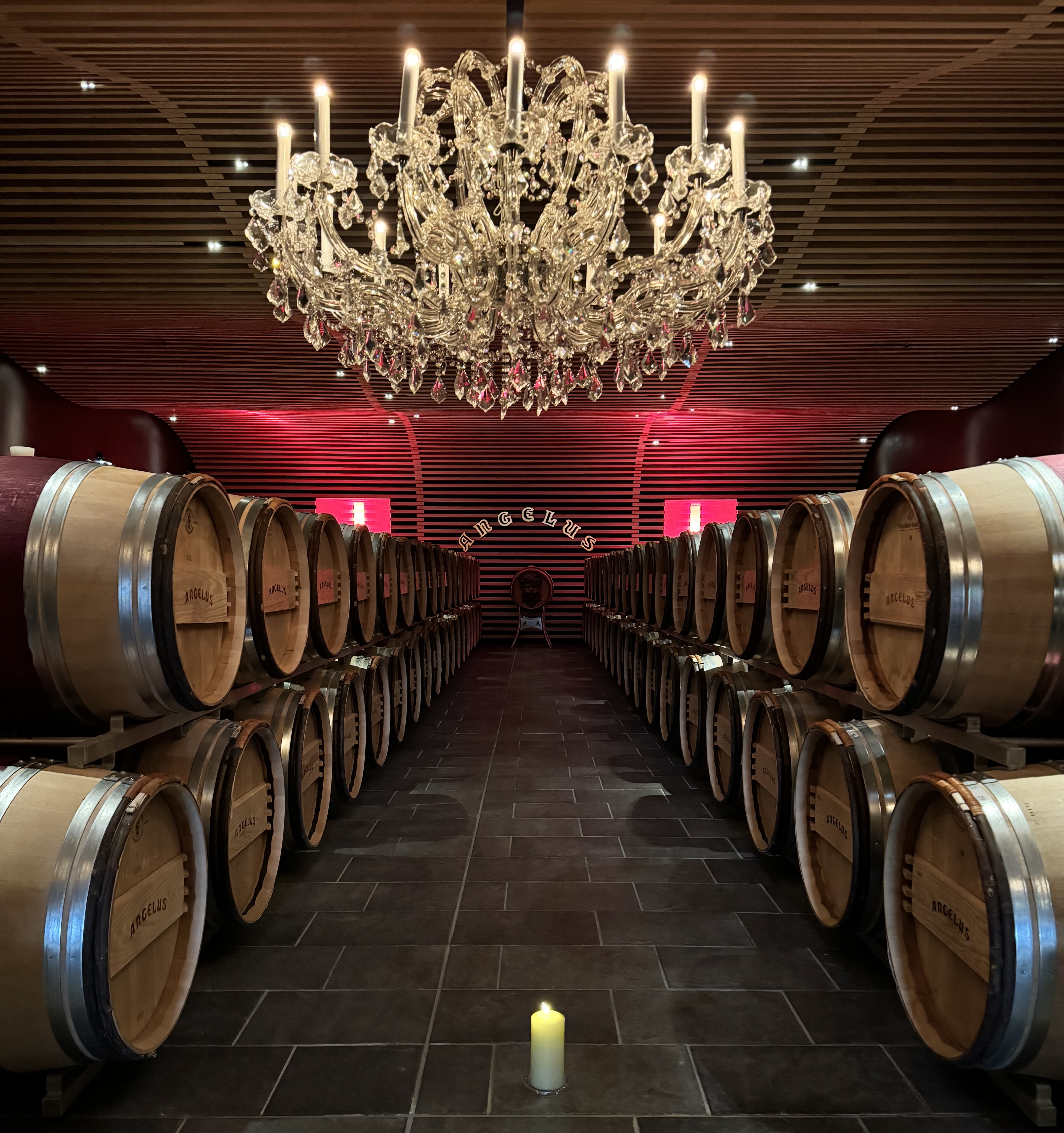 a modern wine cellar with a candle and chandelier