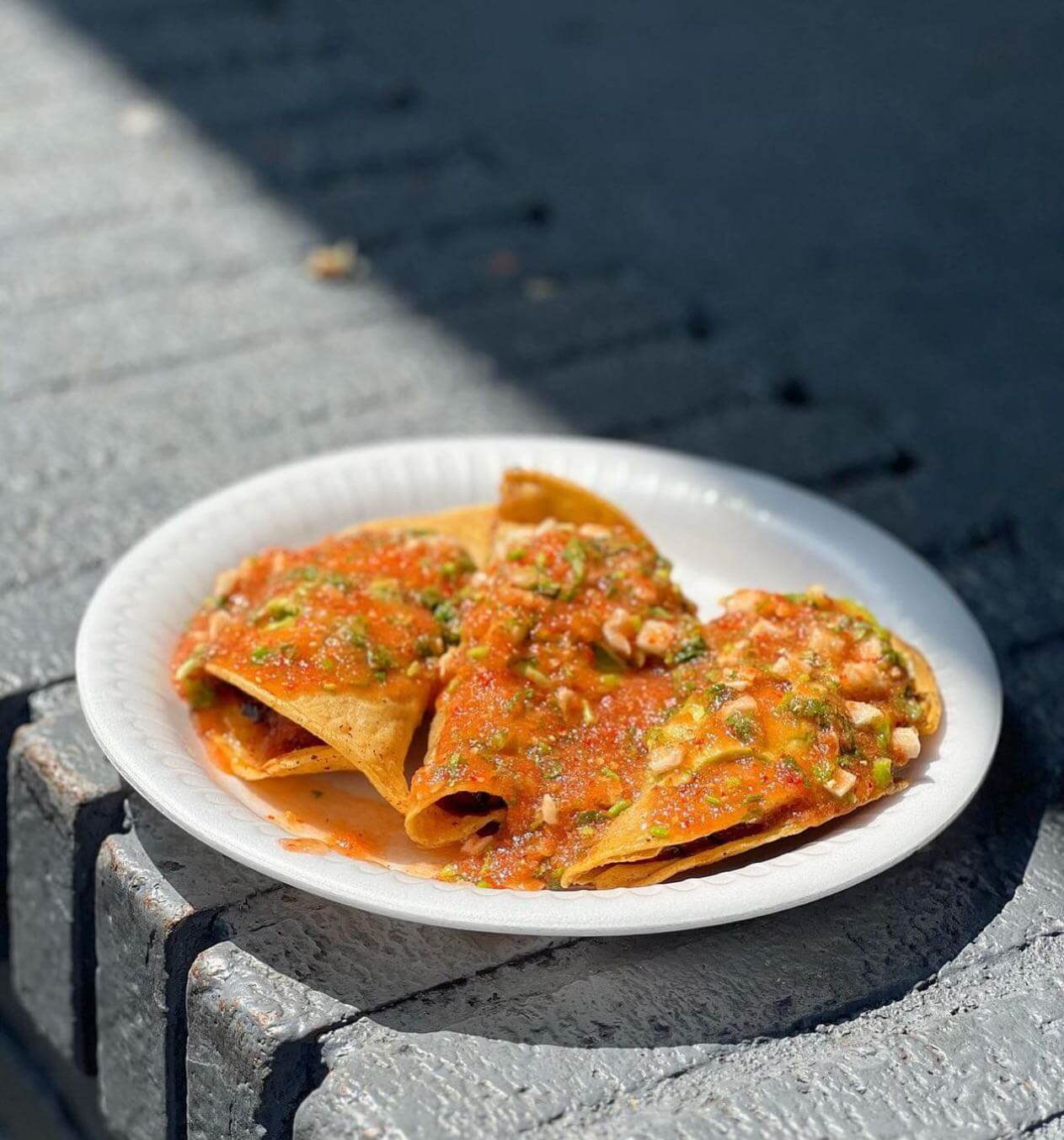 The crispy shrimp tacos from Mariscos Jalisco topped with fresh salsa