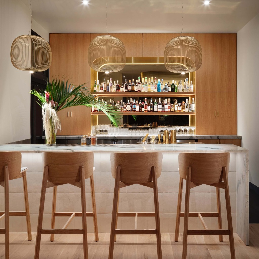 a modern bar with wooden chairs