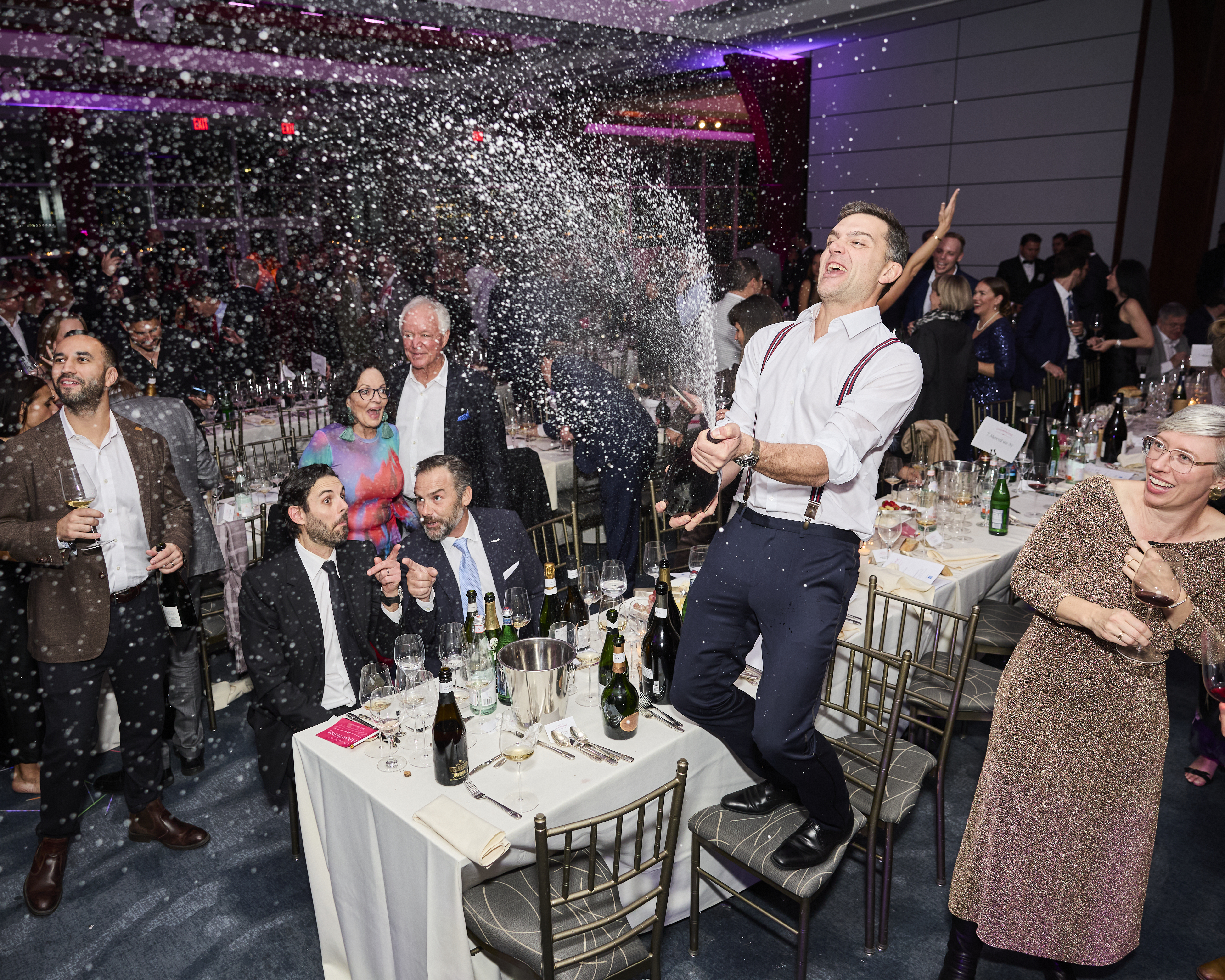 A man pops champagne at the 2024 La Fete du Champagne Gala Dinner. Photo courtesy of @jamescfrench