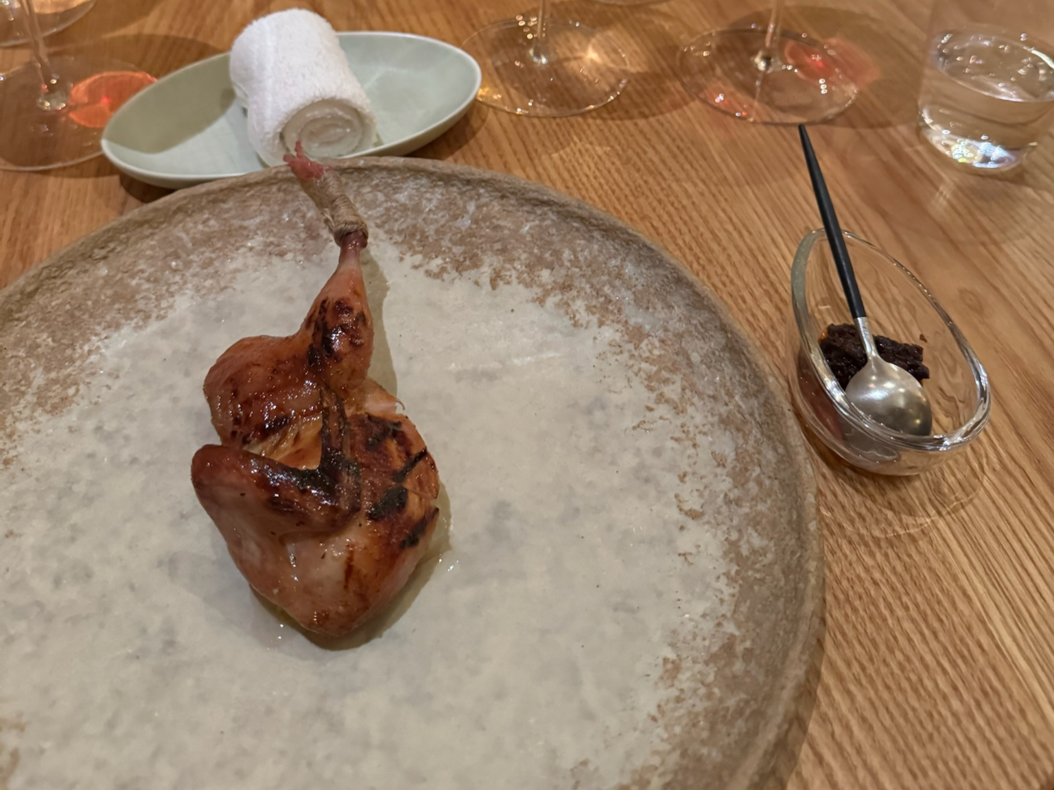 Lacquered and Smoked Quail with a condiment of innards, broth of grilled bones
