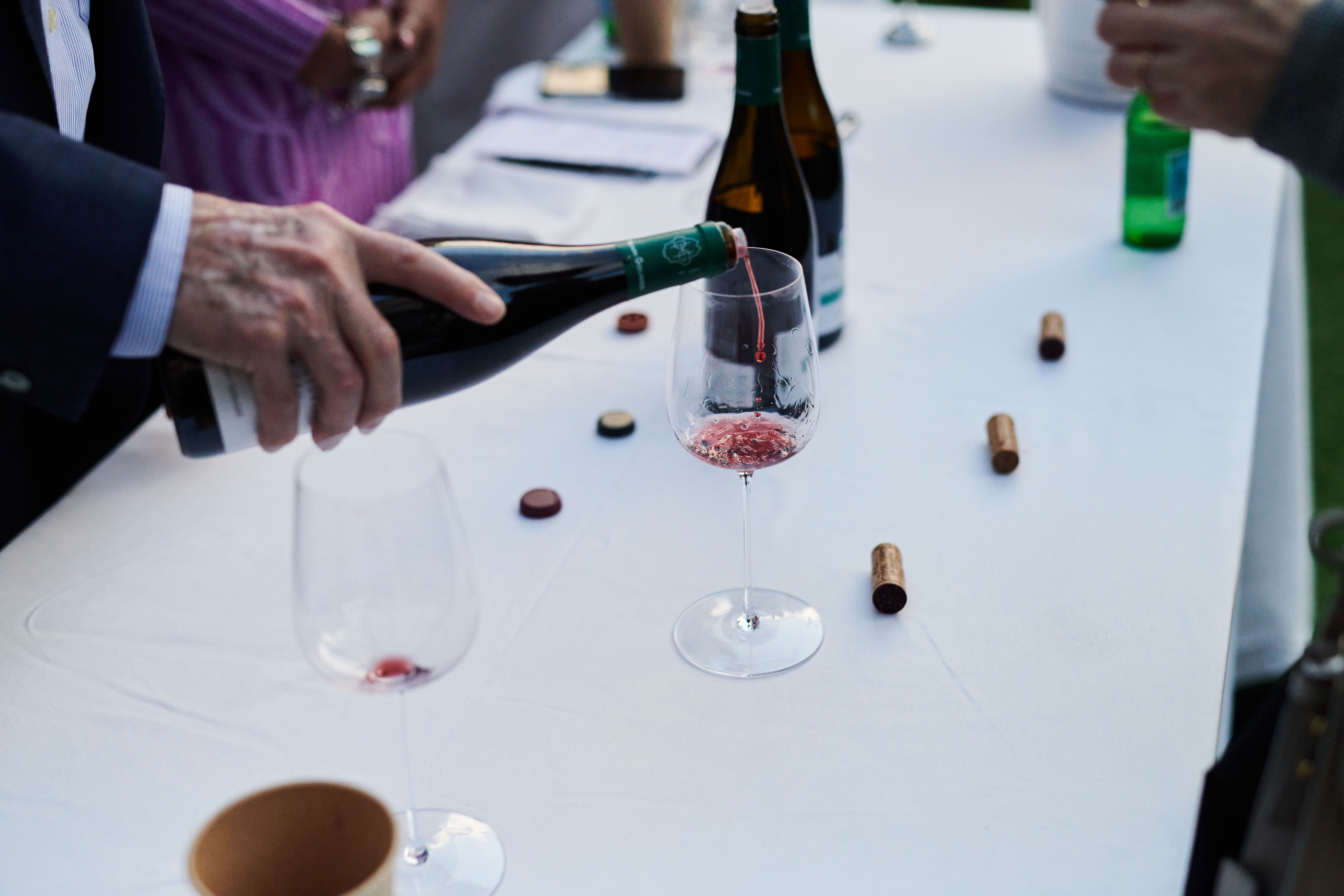 A man pouring a taste of wine at La Paulee Los Angeles