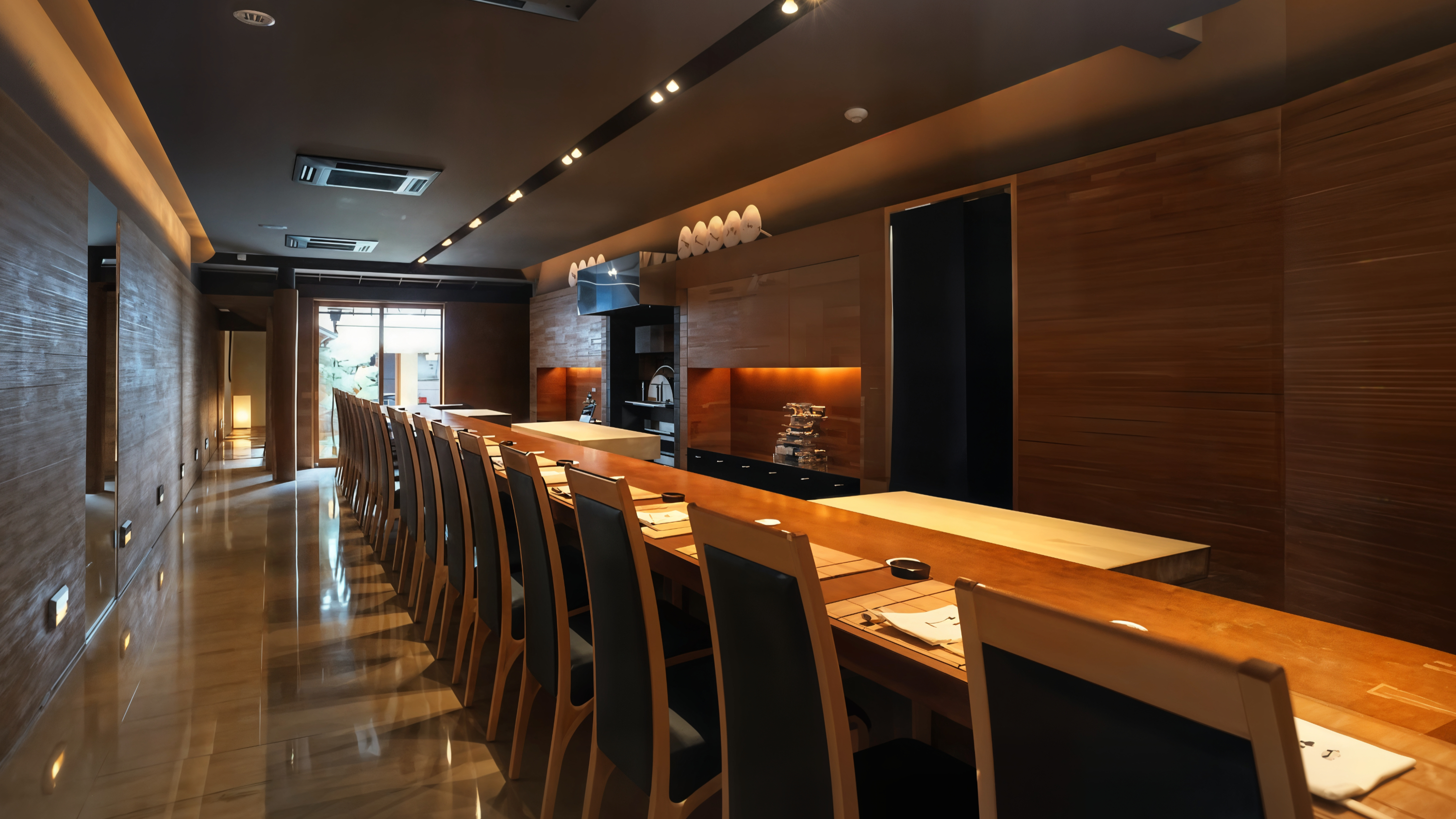 Empty, warm-lit sushi bar with wooden chairs and counter, set for dining. Modern, minimalist design with a cozy, inviting atmosphere.