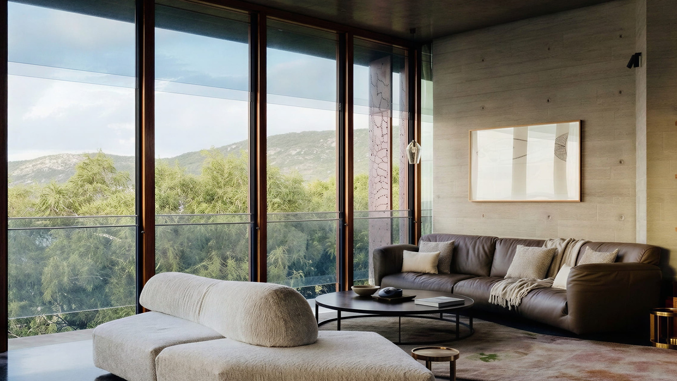 The upstairs living room of The House at Lizard Island Resort with large windows, a beige sectional sofa, and brown leather couch. Mountain view outside, neutral tones, calm mood.