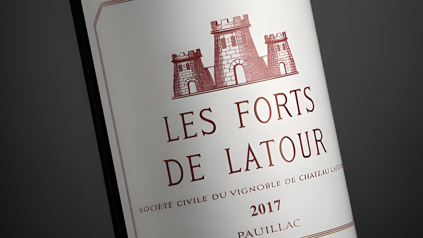 A wine bottle labeled "Les Forts de Latour 2017" with a castle image, set against a dark background; elegant and classic design.